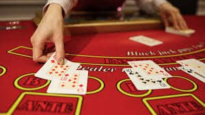 Baccarat cards being dealt showing Player and Banker hands with visible card values and totals